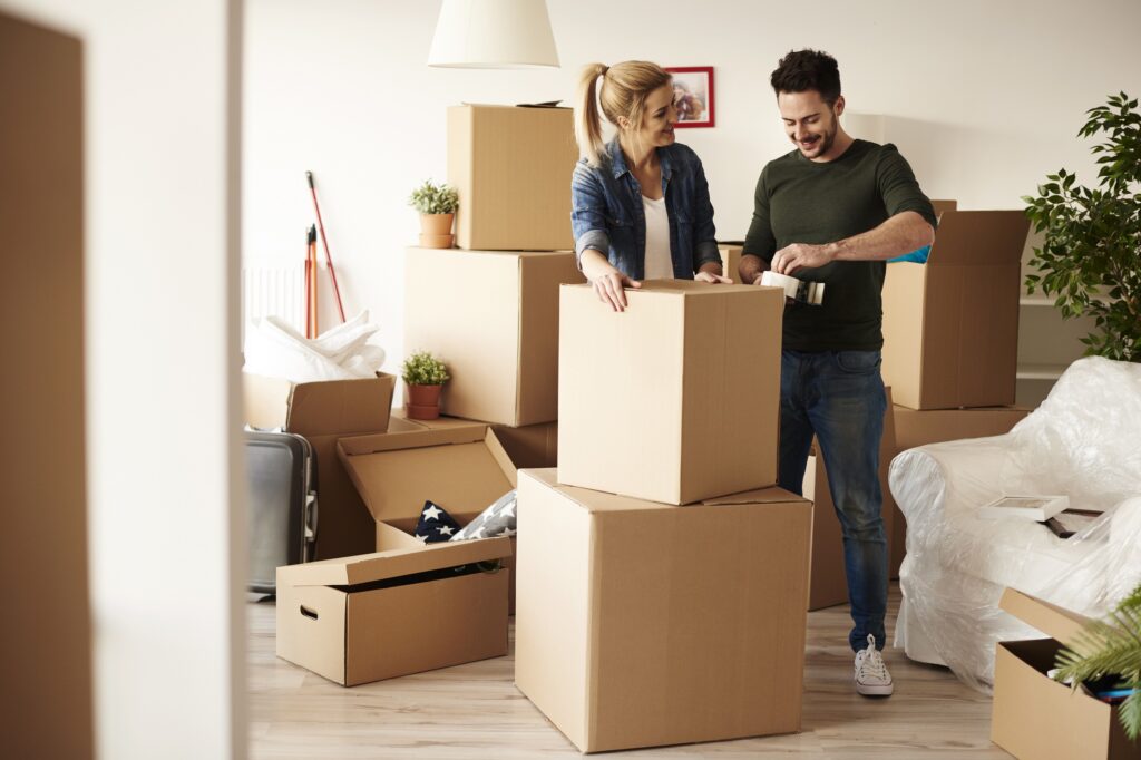 Couple preparing boxes for moving to a new house in Australia