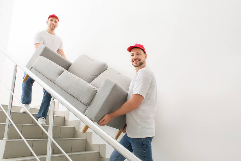 Furniture Removalists Shifting Sofa During House Move
