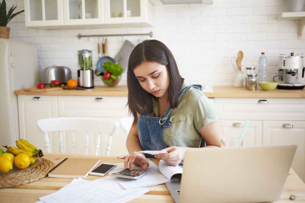 A Woman Calculating Her Utilities and Bills