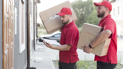 Professional Packers and Movers Working During a Moving Interstate Process Professional Packers and Movers Working During a Moving Interstate Process