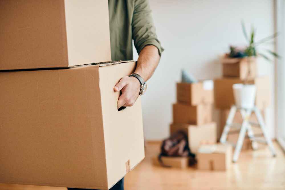 A Man Holding Moving Boxes